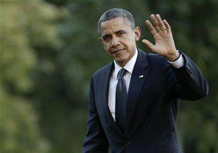 U.S. President Obama waves as he returns to the White House in Washington