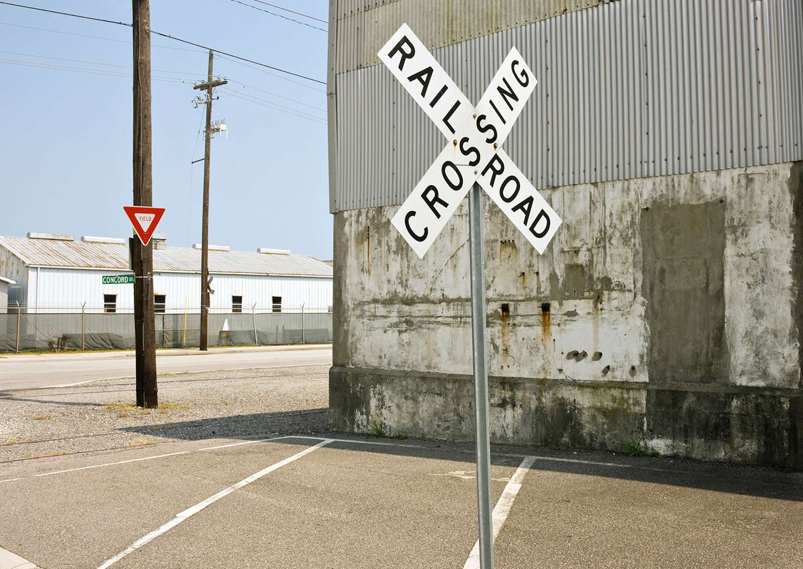 Railroad crossing sign in small town